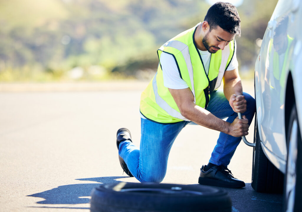 man car changing tyre road mechanical problem with transport gear safety male person auto tool service inspection wheel fixing puncture maintenance countryside
